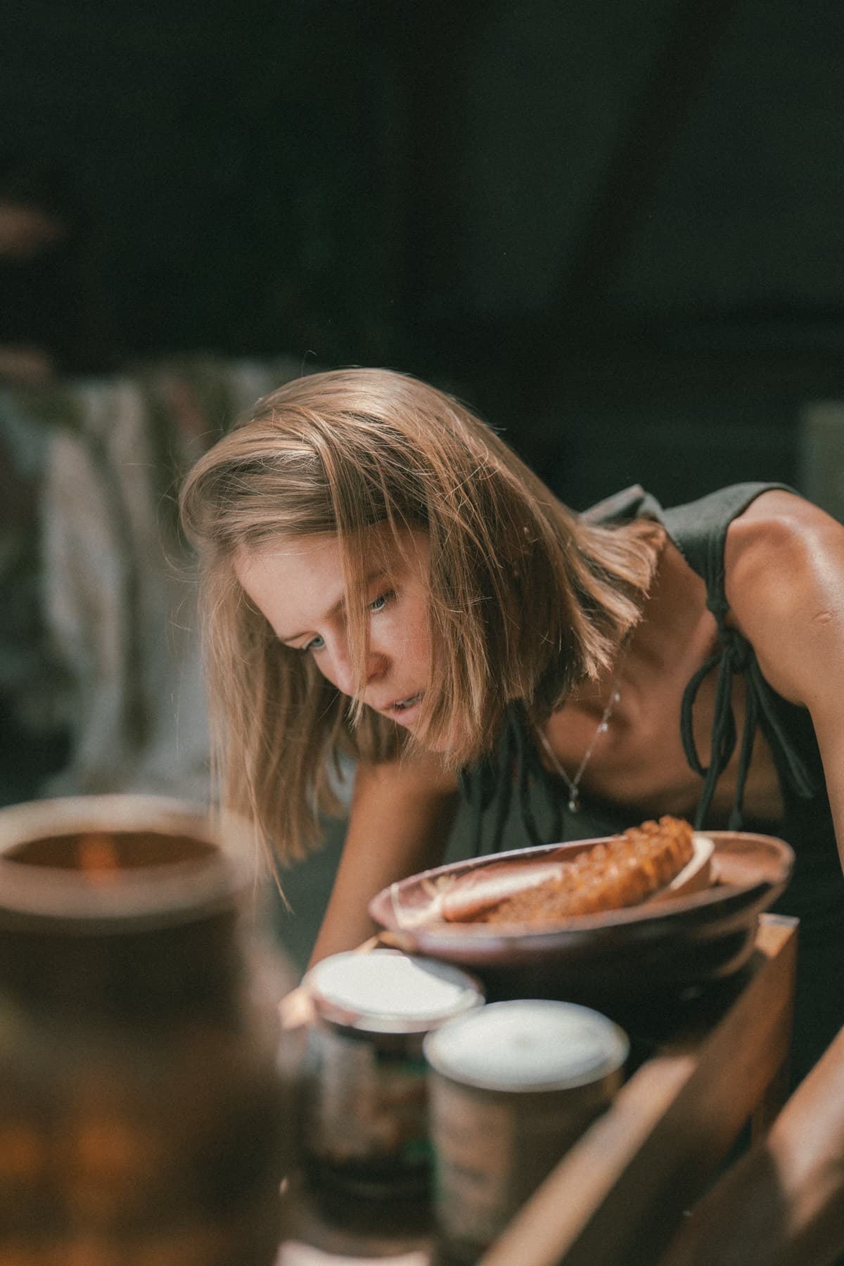 A dish of bread set down on a table at TEJÁ, glasses and cups around it.