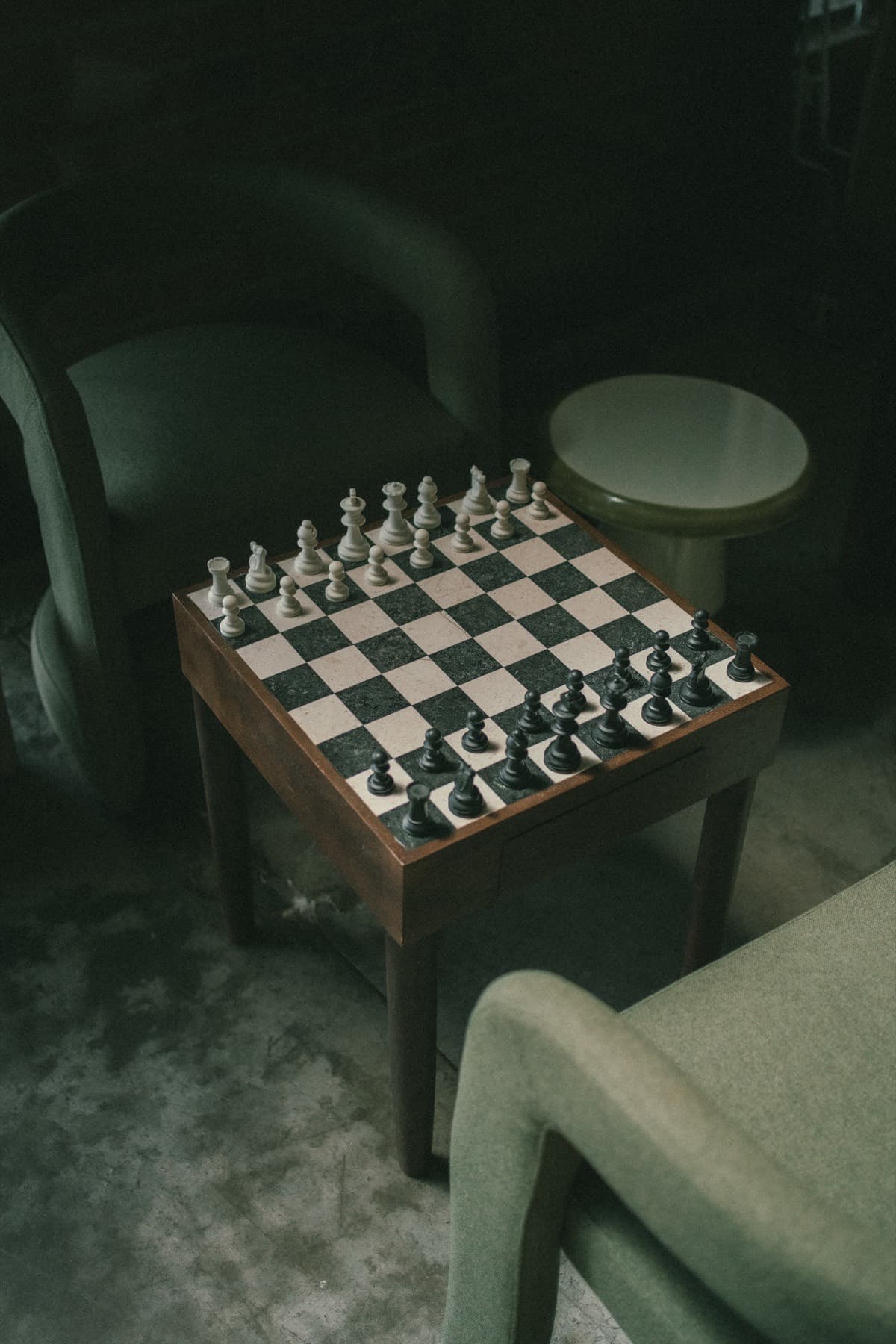A chess set on a low table between two armchairs at TEJÁ.